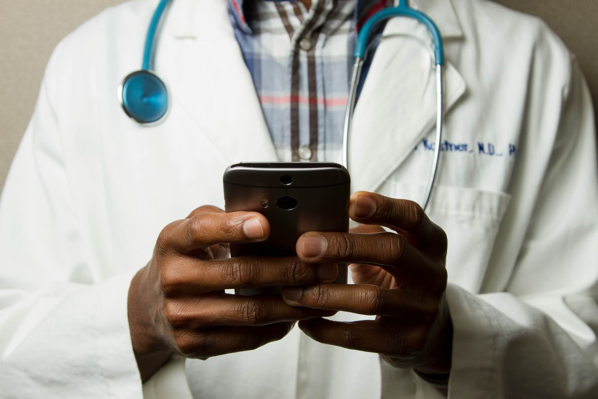 A health professional using a mobile phone